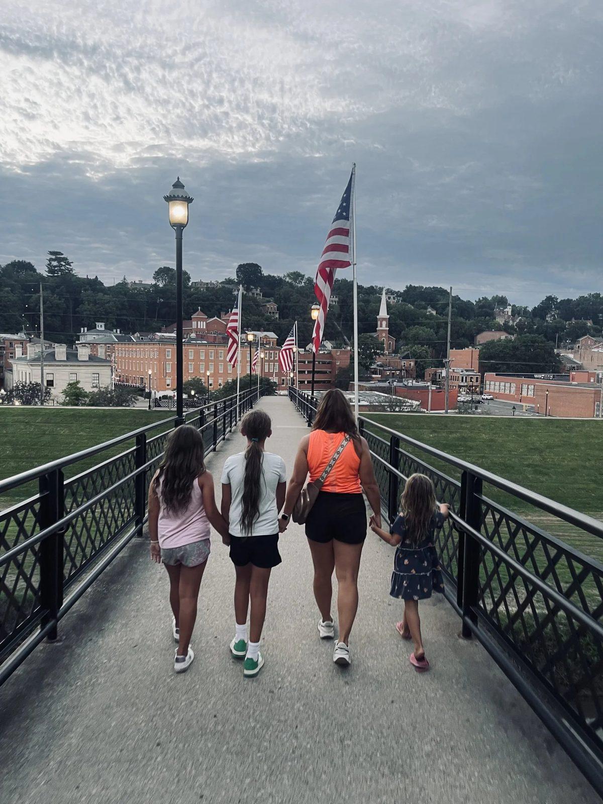 Jeanie and our three girls walking across a bridge